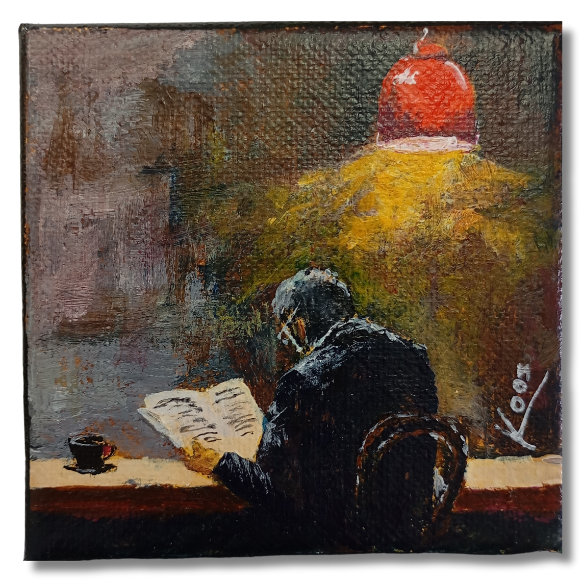 Man reading a book under lamp